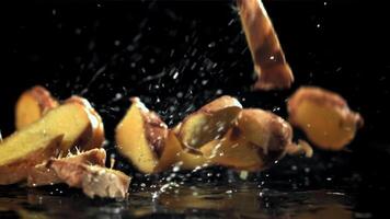 Pieces of fresh ginger fall on the table. Filmed on a high-speed camera at 1000 fps. High quality FullHD footage video