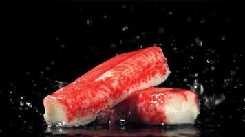 Drops of water fall on fresh crab sticks. Filmed on a high-speed camera at 1000 fps. High quality FullHD footage video