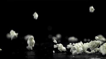 Fresh cottage cheese falling on black background. Filmed on a high-speed camera at 1000 fps. High quality FullHD footage video