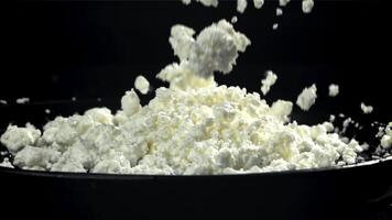 Fresh cottage cheese falls into the plate. Filmed on a high-speed camera at 1000 fps. High quality FullHD footage video