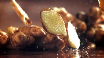 Pieces of fresh ginger fall on the table. Filmed on a high-speed camera at 1000 fps. High quality FullHD footage video