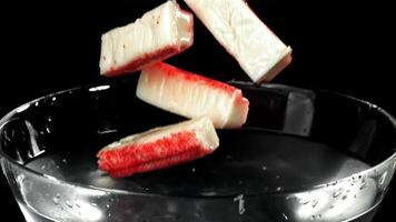 Crab sticks fall into the water. Filmed on a high-speed camera at 1000 fps. High quality FullHD footage video