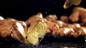 Pieces of fresh ginger fall on the table. Filmed on a high-speed camera at 1000 fps. High quality FullHD footage video