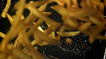 The fries fall into the hot oil. Filmed on a high-speed camera at 1000 fps. High quality FullHD footage video