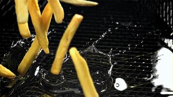 The fries fall into the hot oil. Filmed on a high-speed camera at 1000 fps. High quality FullHD footage video