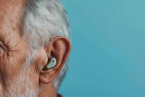 AI generated Ear of an elderly person with hearing aid on blue background photo