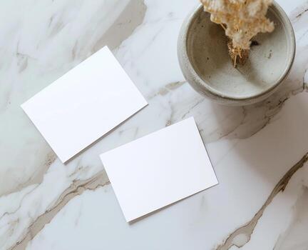 AI generated Two blank white business cards resting on a marble desktop surface, personal branding image photo