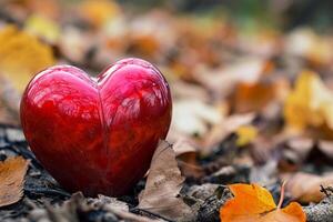 AI generated A red heart sits on top of a pile of leaves photo