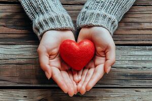 AI generated A pair of hands holds a small red heart set against the backdrop of a rustic wooden surface photo