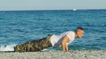 Soldier does push ups on the beach video