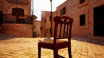 A wooden chair sitting on top of a cobblestone street video