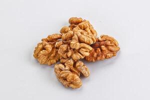 Cracked kernel walnut heap isolated photo