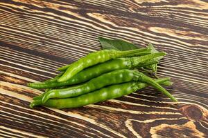 Spicy green chili pepper heap photo