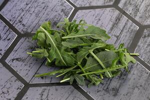 Green Arugula heap over background photo