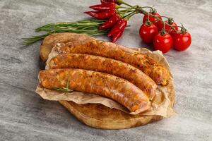 Raw sausages with spices and herbs photo