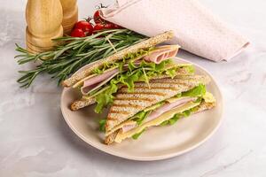 Homemade club sandwich with ham and cheese photo