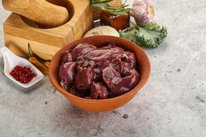 Raw uncooked chicken liver in the bowl photo