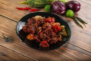 Asian cuisine - pork with chili sauce photo