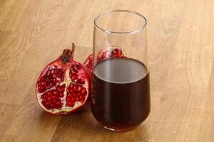 Sweet pomegranate juice in glass photo