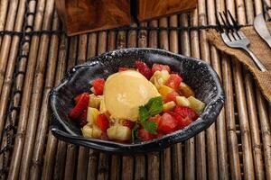 Sweet fruit salad with ice cream photo