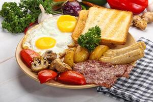 English breakfast with toast, egg and sausages photo