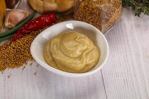 Dijon mustard sauce in the bowl photo