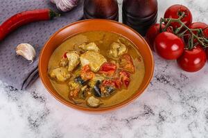 Traditional yellow Thai curry with chicken photo