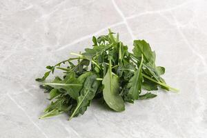 Green Arugula heap over background photo