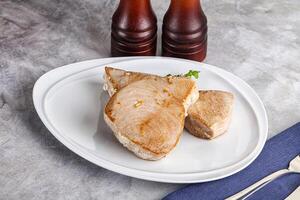 Roasted red tuna steak in the plate photo