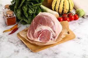 Uncooked raw pork knuckle with spices photo