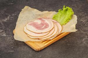 Sliced Pancetta sausage over board photo