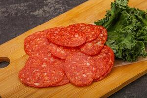 Italian spycy pepperoni sausage slices photo