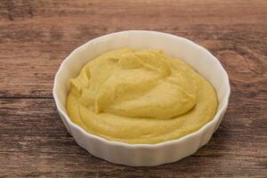 Dijon mustard sauce in the bowl photo