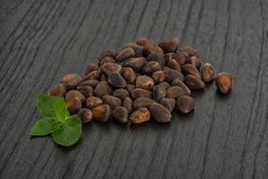 Cedar nuts over board photo