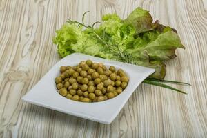 Marinated peas in the plate photo