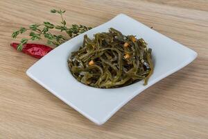 Laminaria salad in the plate photo