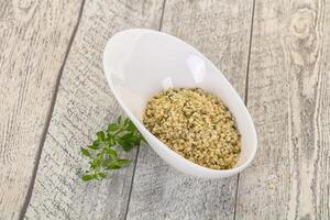 Peeled hemp seeds in the bowl photo