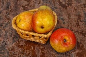 Pear heap in the wooden basket photo