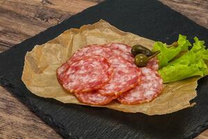 Spanish Salchichon sausage with salad photo