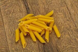 Raw penne pasta for bowl photo