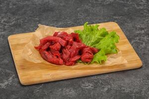 Raw beef meat sliced for cooking photo