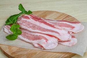 Raw bacon slices photo