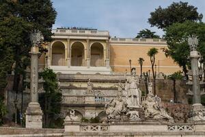 sculpture and fountain of Piazza del Popolo . The steps lead up to the pincio park, Rome, Italy photo