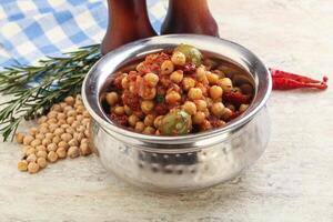 Chickpea beans with dry tomato and olives photo