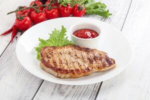 Grilled pork steak with ketchup photo