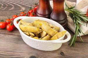 Grilled artichoke marinated in oil photo