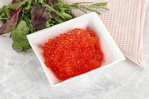 Red caviar in the bowl photo