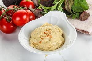 Creamy hummus in the bowl photo