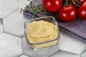 Dijon mustard sauce in the bowl photo