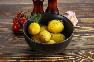 Boiled potato with oil and dill photo